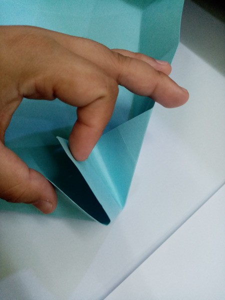 How to Make a Paper Office Supplies Container - pull the corners together and push the tip inside