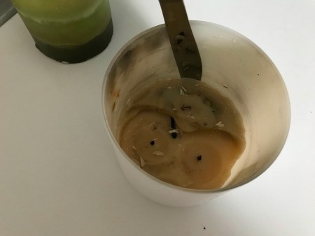 Popping out the frozen wax from a candle holder.