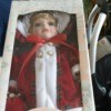 Value of Leonardo Collection Porcelain Dolls - doll wearing a red coat trimmed in white - still in box