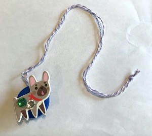 How to Make a Bottle Cap Necklace for Toddlers - finished necklace with a dog on the front