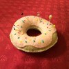 Donut Pin Cushion - pink frosted donut pincushion on red background
