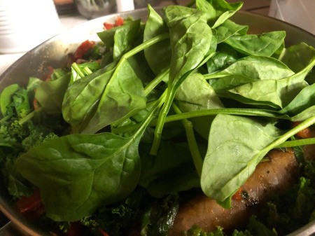 Kale & Spinach topping Sausage  in Skillet