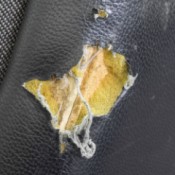 A torn seat on a dining room chair.