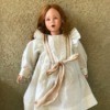 Identifying a Porcelain Doll - doll wearing period dress and high top shoes, has pink eyes