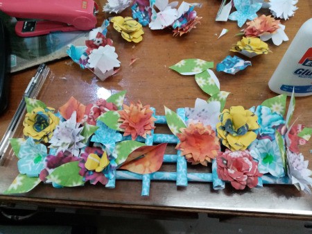 How to Make Paper Flower Wall Decor - cover the entire "fence" with flowers