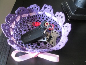 How to Make a Stiffened Doily Bowl - car keys in purple bowl which has had a pink ribbon laced through it