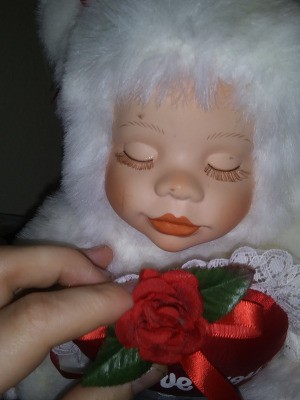 Value of Classical Treasures Porcelain Dolls - doll wearing a white fur suit with a red heart on the front
