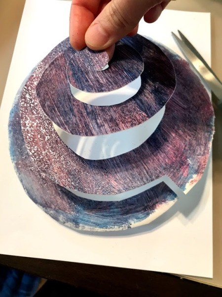 Rocket Paper Twirler Room Decor - fingers holding up the center of the spiral