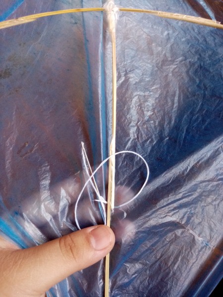How to Make a Mini Kiddie Kite - sew through the plastic and round the stick