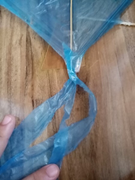 How to Make a Mini Kiddie Kite - attach the strips to the bottom end of the vertical stick