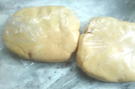 dough halves wrapped in plastic