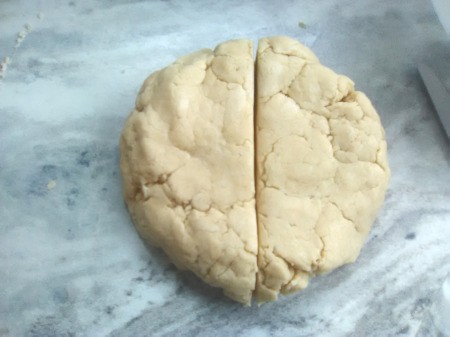 dough flattened ball cut in half