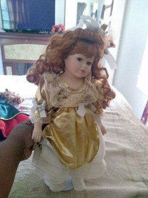 Value of Seymour Mann Dolls - doll wearing a long dress with a gold overshirt