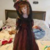 Identifying a Porcelain Doll - doll wearing a long dark red dress with hat and black lace veil