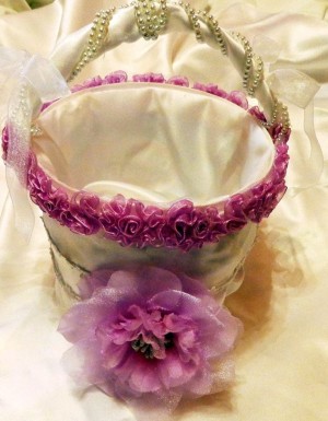Homemade Recycled Flower Girl Basket - white fabric covered bucket with purple-red flowers around the top and a large flower on the front