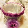 Homemade Recycled Flower Girl Basket - white fabric covered bucket with purple-red flowers around the top and a large flower on the front