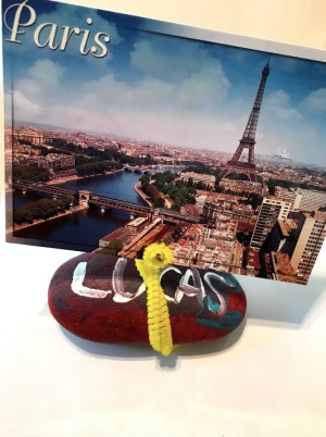 Photo Holder Rock - rock holding a photo of Paris, perhaps a postcard