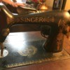 Value of an Antique Singer Sewing Machine - black Singer machine with gold lettering