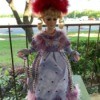 Identifying a Porcelain Doll - doll wearing a feather hat and long dress