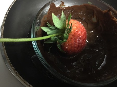 dipping Strawberries in bowl