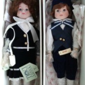 Value of a Pair of Dynasty Porcelain Dolls - dolls in boxed wearing navy and black clothing over white shirt or blouse