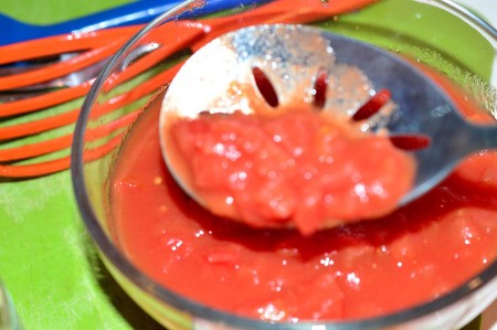 straining diced tomatoes