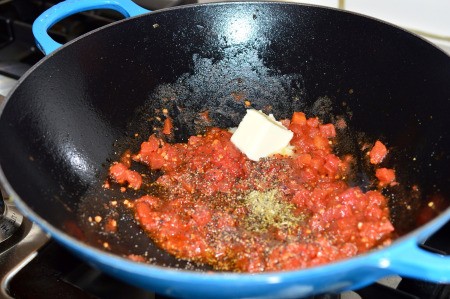 tomatoes in pan with seasoning