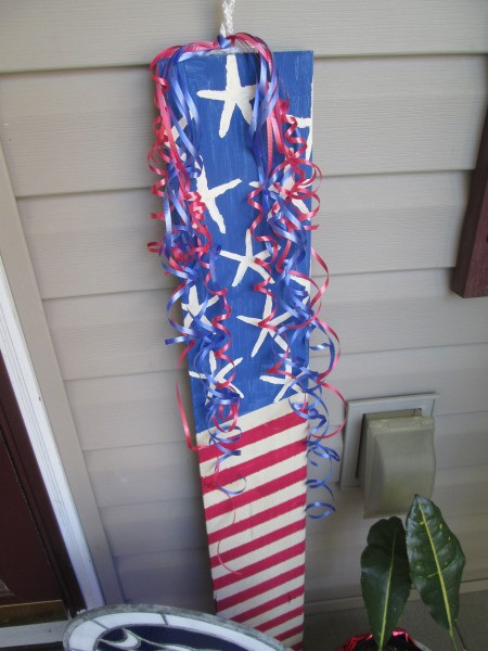 Making A Patriotic Flag With Left Over Wood - red, white, and blue curly ribbon tied to cord