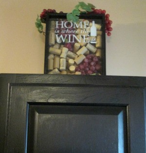 Using My Collection Of Wine Corks For Decorating - finished wine and cork decor on top of a black cabinet