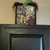 Using My Collection Of Wine Corks For Decorating - finished wine and cork decor on top of a black cabinet