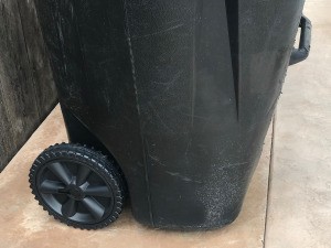 A trash bin with newly repaired wheels.