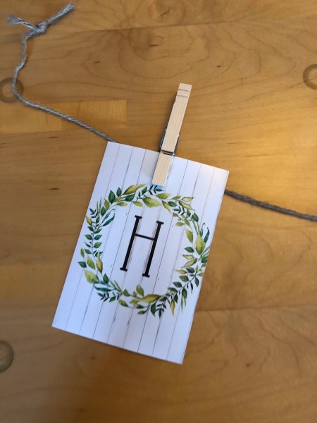 Home Banner - begin attaching the printouts to the length of twine using clothes pins