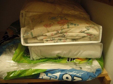 Linens stored in a recycled Bounty paper towel