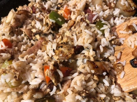 mixing rice with egg, bacon & veggies