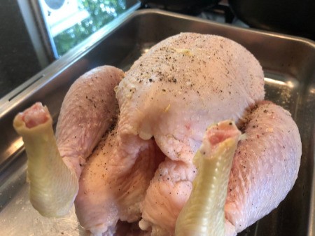 seasoned whole Chicken in pan