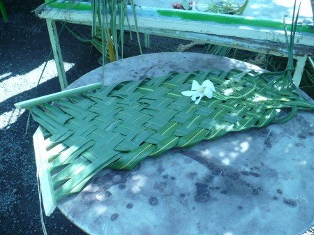 Weaving Coconut Leaf Plates - finished plate sitting on an outside table