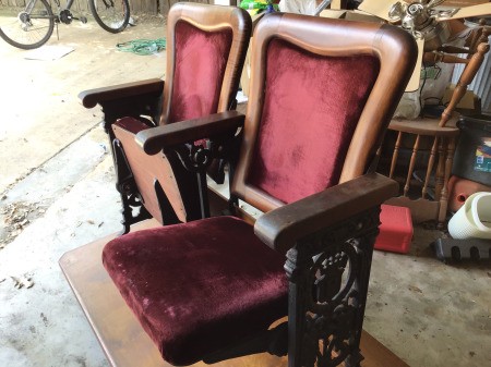 Identifying Theater Seats and Age - upholstered seats, with wood trim, and ornate cast sides