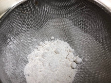 sifting sugar in bowl