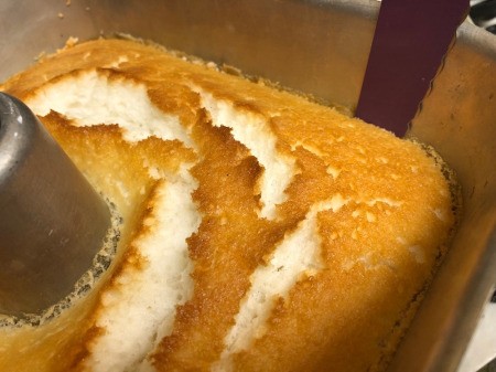 cutting edges of cake to remove from pan