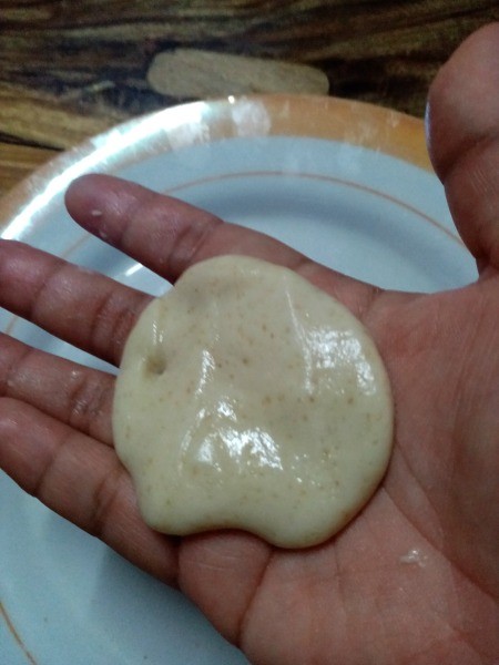 flattened dough in hand