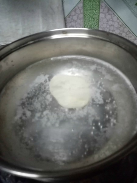 dropping dough insimmering pan of water