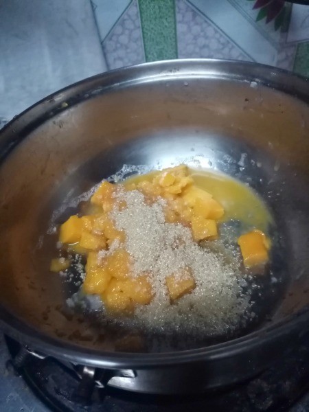 mango chunks & sugar in pan