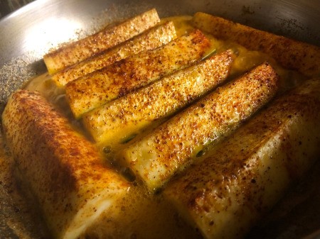 Zucchini quarters in pan