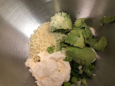 mixing avocado, Parmesan, & mayo
