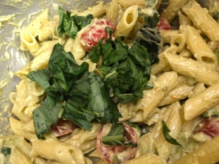 adding more basil to pasta salad