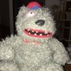 Identifying a Stuffed Bear - scraggly grey bear wearing a school type cap