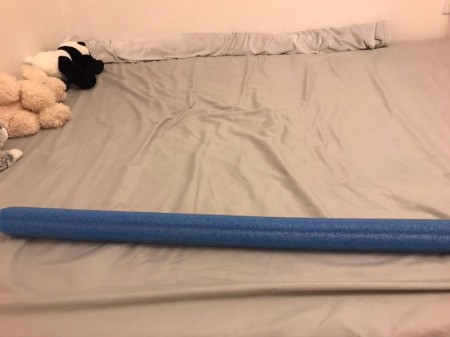 A pool noodle on top of a mattress.