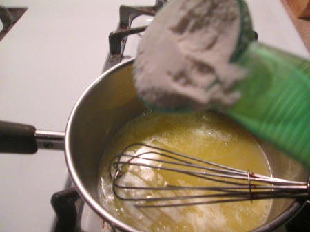 adding flour to butter in pan