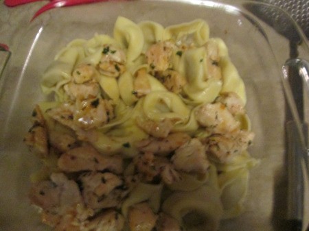 sauce, chicken, parsley on pasta in dish