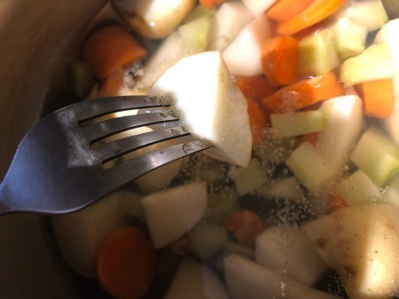 checking to see if veggies done with fork